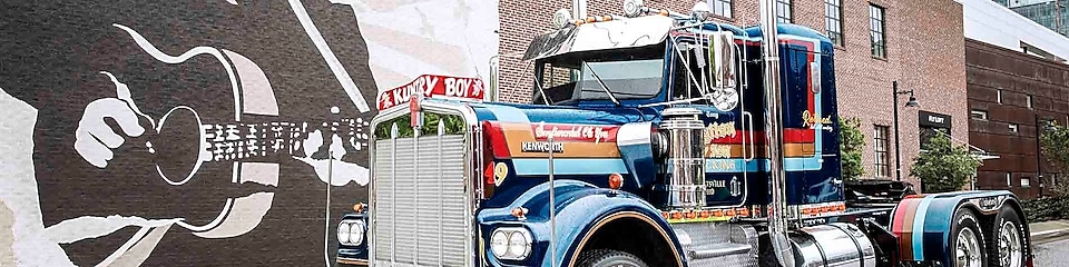 Truck parked near a painted wall