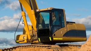 Construction workers and excavator