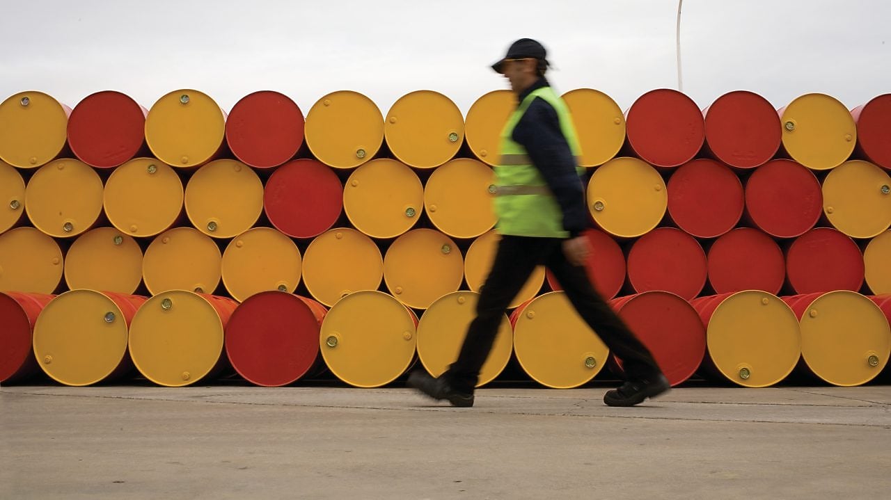 Man walking infront of barrels