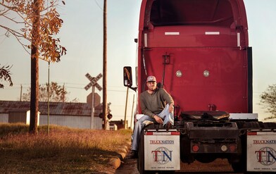 Guy sitting behind truck 1